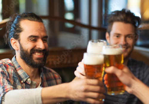 Photography happy male friends drinking beer at bar or pub