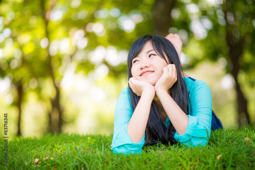 beautiful asian girl lying down on green grass beautiful asian girl lying down on green grass