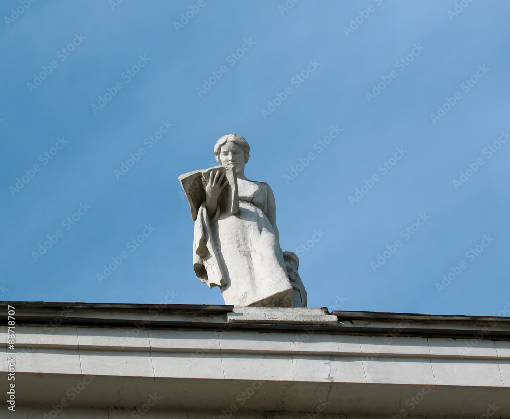 Statue of a girl on a building in downtown Moscow