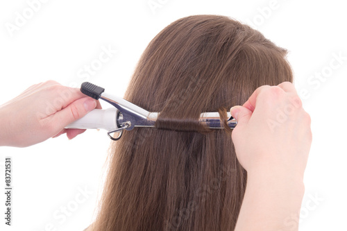 hairdresser curling hair to woman isolated on white