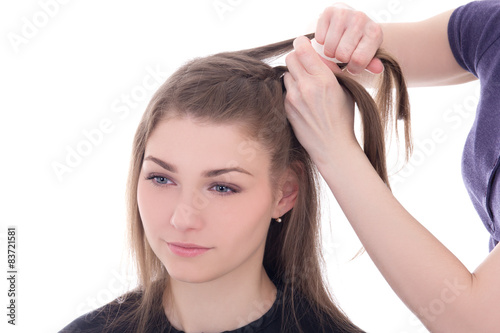 hairdresser doing haircut to beautiful woman isolated on white