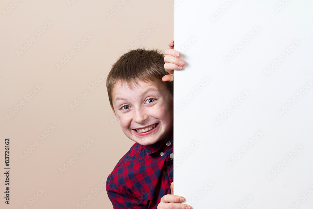 Smiling little boy with white blank placard, board,poster. Smiling little boy with white blank placard, board,poster.