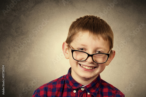 Confident little boy nerd ,holding a puzzle cube