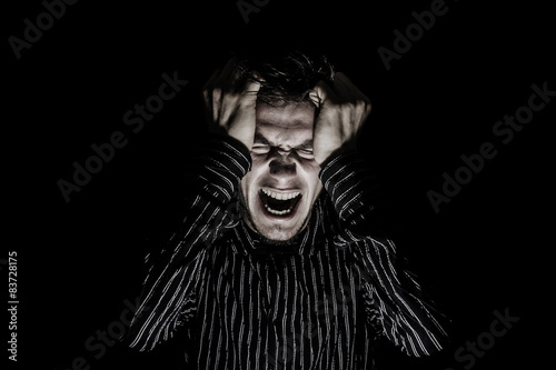 Screaming Stressed, aggressive portrait of a young student, man