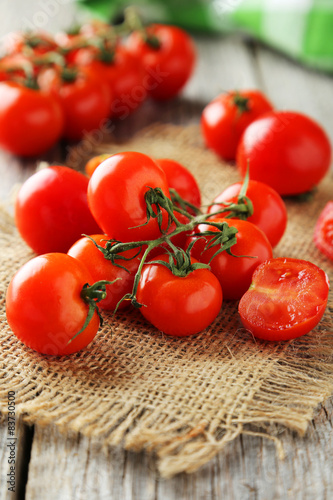 Fresh cherry tomatoes on grey wooden background