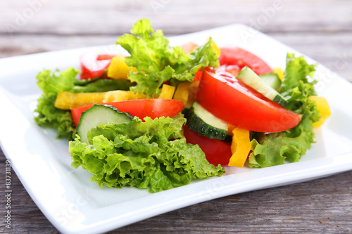 Fresh vegetable salad on grey wooden background