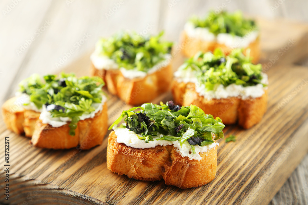 Tasty fresh bruschetta on cutting board on grey wooden backgroun