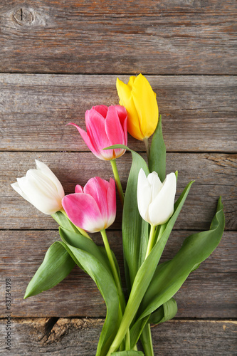 Beautiful tulips on grey wooden background