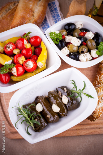 Vine leaves stuffed with peppers and Mediterranean antipasti