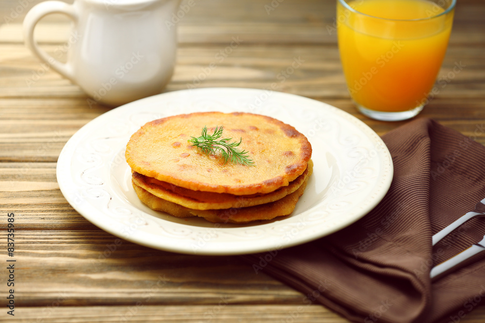 Stack of corn tortillas with stuffing and glass of juice on wooden table background Stack of corn tortillas with stuffing and glass of juice on wooden table background