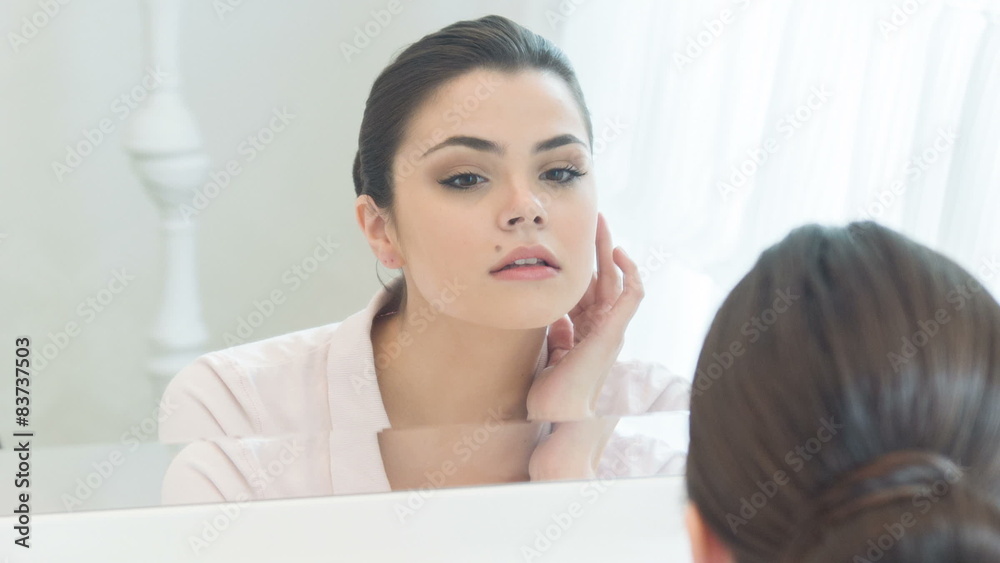 Young woman setting right her make-up Young woman setting right her make-up
