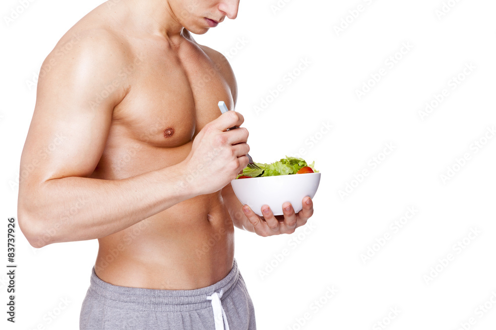 Fit man holding a bowl of salad, isolated on white background Fit man holding a bowl of salad, isolated on white background