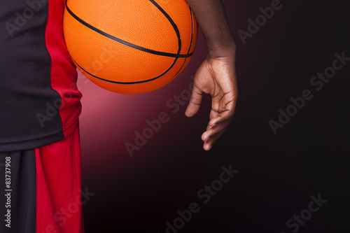Rear view of a basketball player holding a basketball against da © cristovao31
