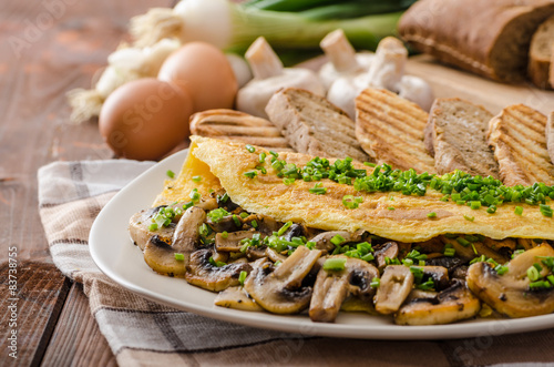 Rustic omelette with mushrooms on chives