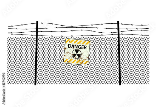 sign radiation on  steel fencing with a barbed wire
