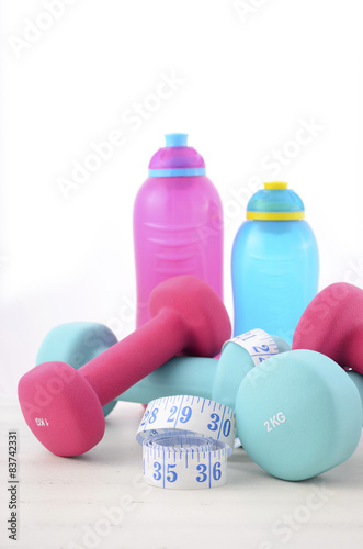 Health and fitness concept with feminine dumbbells