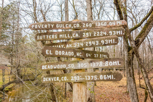wooden direction sign in the forest