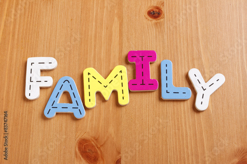 Wallpaper Mural FAMILY, spell by woody puzzle letters with woody background Torontodigital.ca