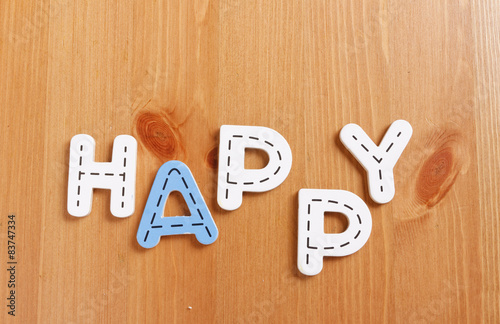 Wallpaper Mural HAPPY, spell by woody puzzle letters with woody background Torontodigital.ca