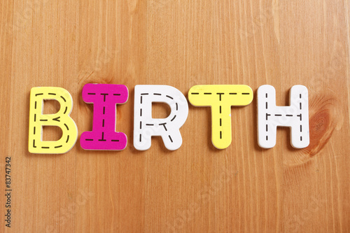 Wallpaper Mural BIRTH, spell by woody puzzle letters with woody background Torontodigital.ca