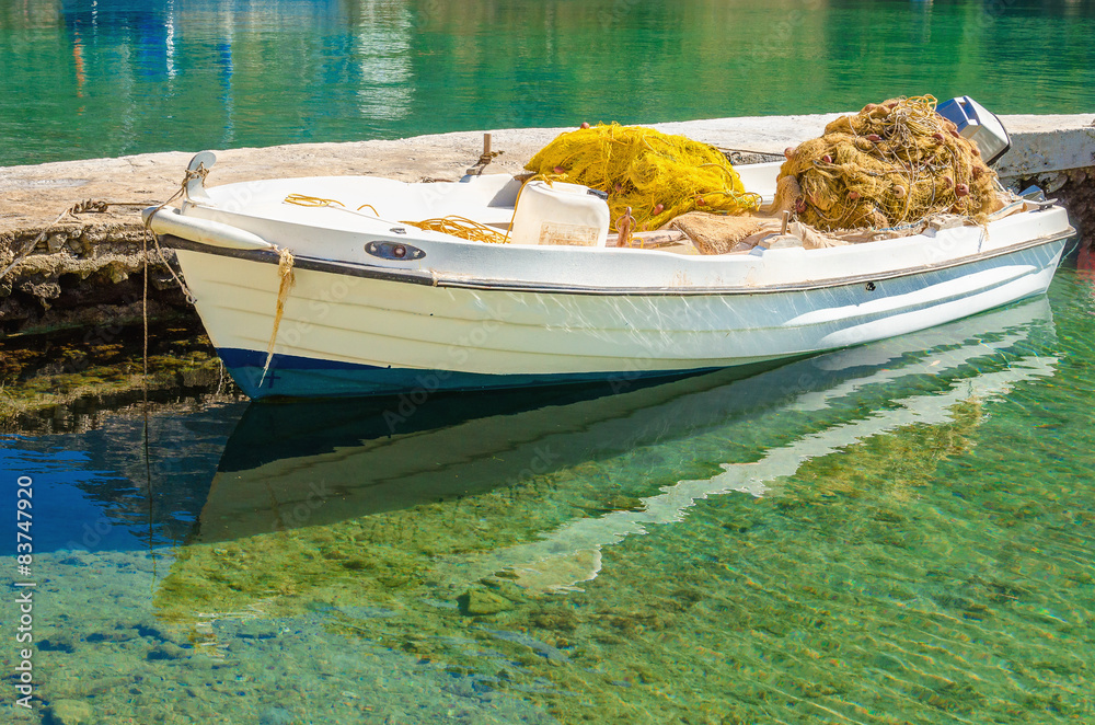 Obraz premium White boat with fisherman's net