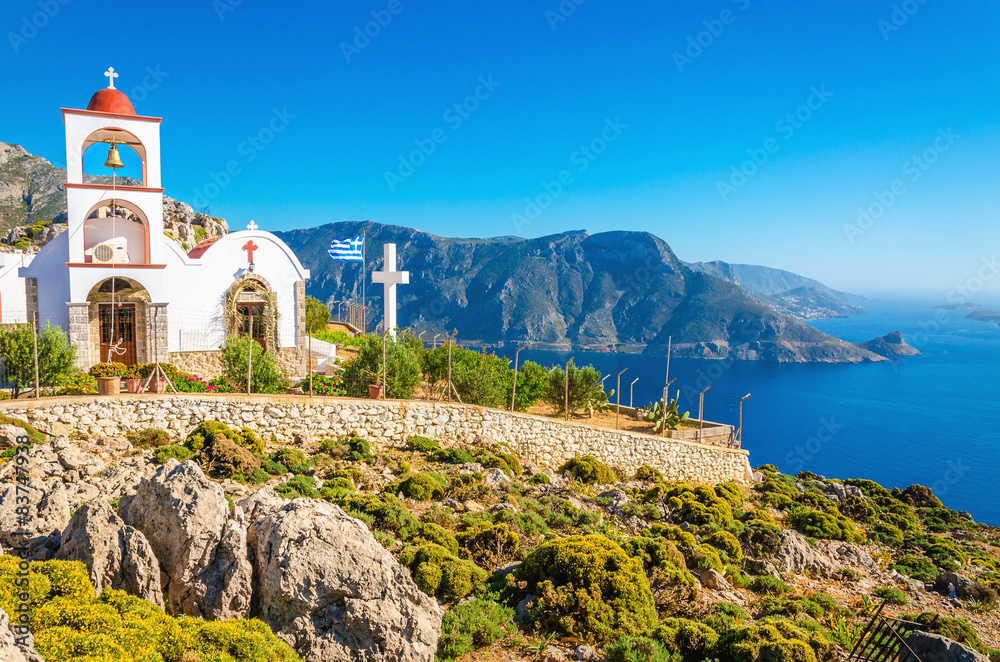 Iconic church with red roof on cliff, Greece