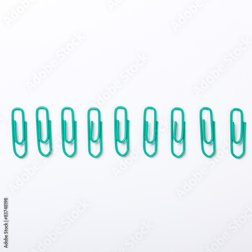 Image of green paper clips isolated on white background