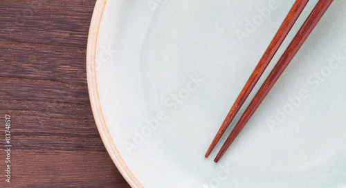 Wood chopsticks and celadon ceramic on wood table 