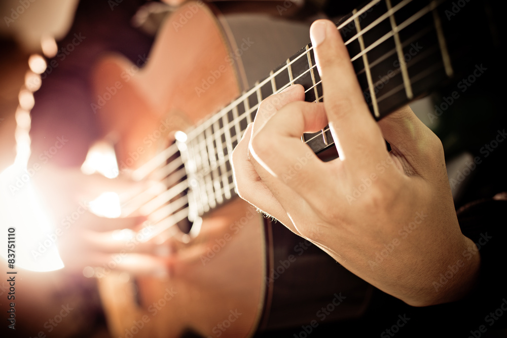 Fototapeta premium Practicing in playing guitar. Handsome young men playing guitar