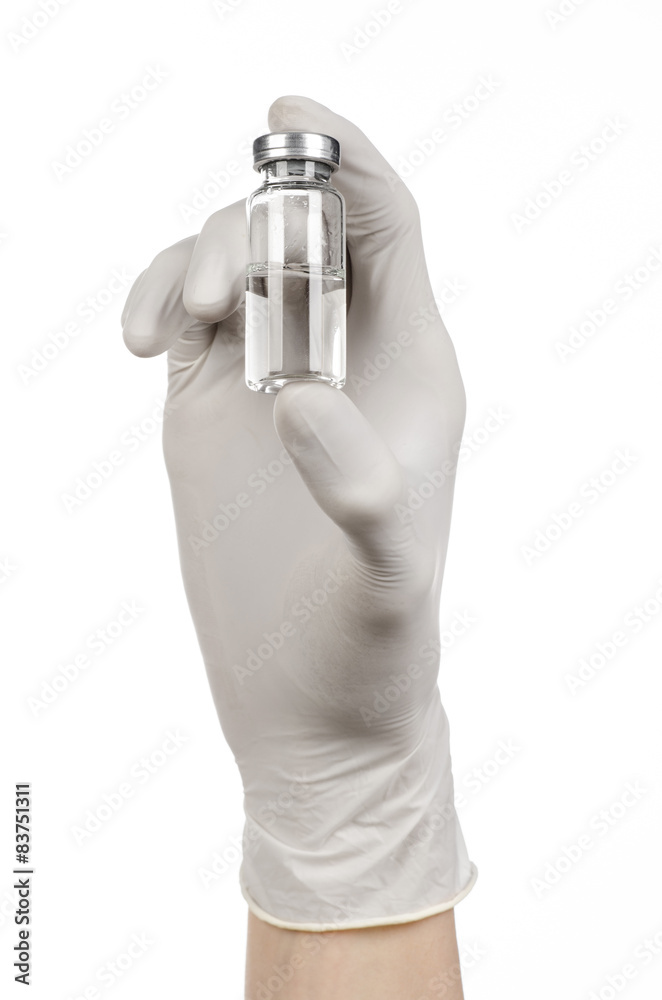 doctor's hand in a white glove holding a vial of clear liquid doctor's hand in a white glove holding a vial of clear liquid