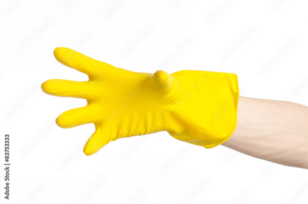 Fototapeta man's hand holding a yellow and wears rubber gloves in studio
