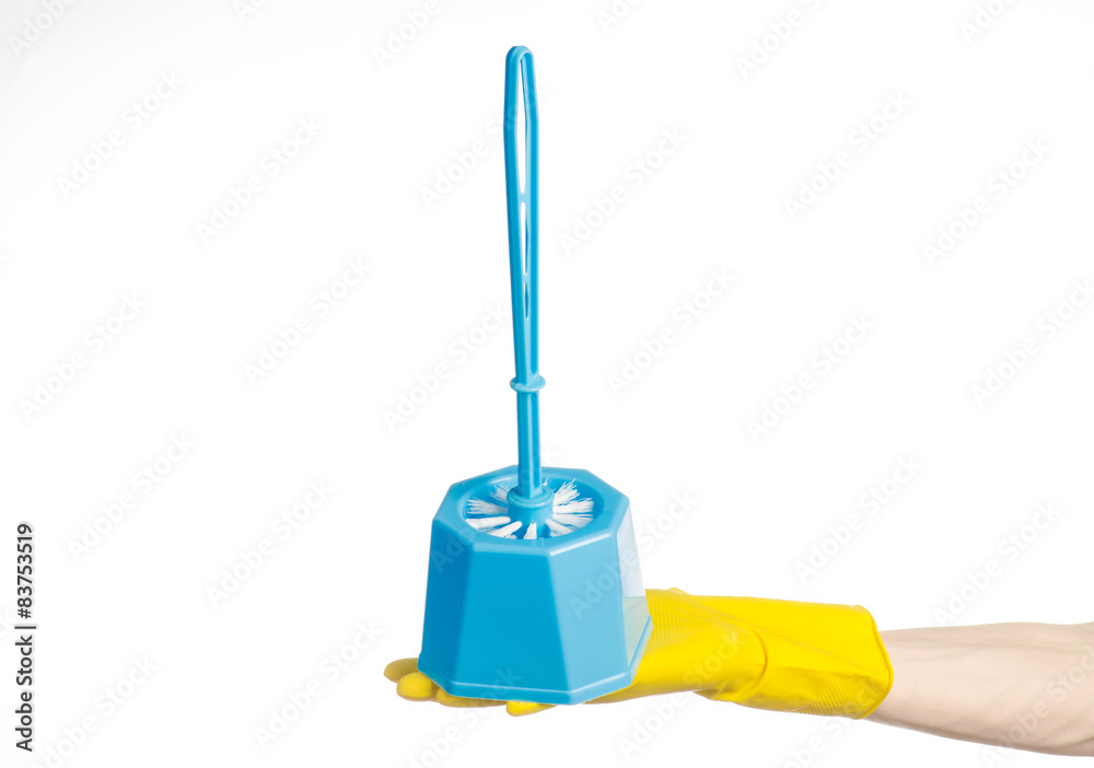 Fototapeta premium human hand holding a blue toilet brush in yellow gloves