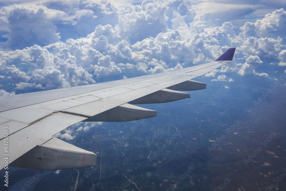 Obraz premium View of cloud with wing of airplane from window