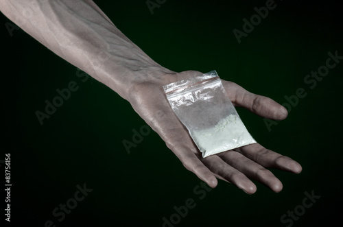 dirty hand holding a bag addict cocaine in the studio