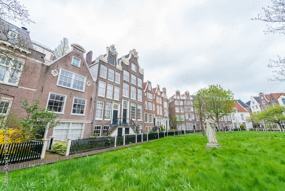 Begijnhof courtyard with  garden surrounded by historic houses i