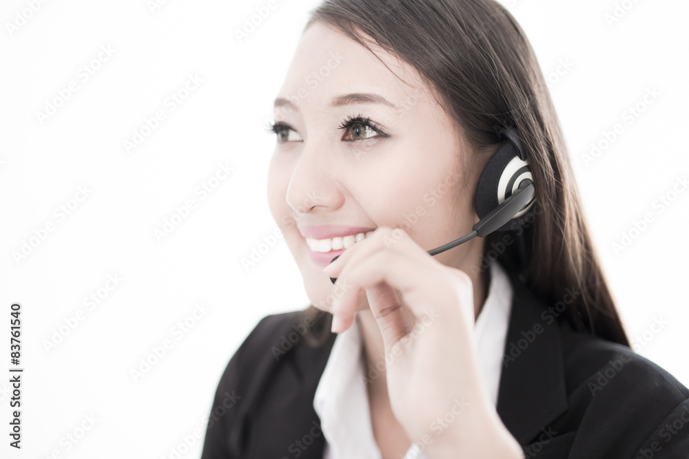 businesswoman talking on the phone while working on her computer businesswoman talking on the phone while working on her computer
