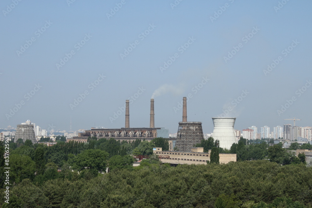 Chimney of a Power plant against blue sky Chimney of a Power plant against blue sky