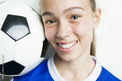 girl in sport wear with football isolated on white background photo