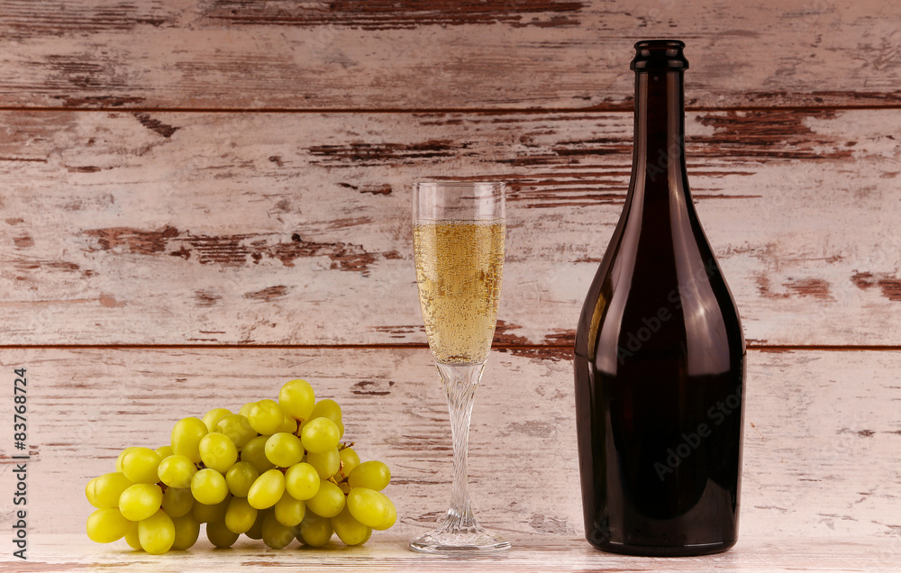 Obraz premium glass of wine, a bottle of wine and grapes on board