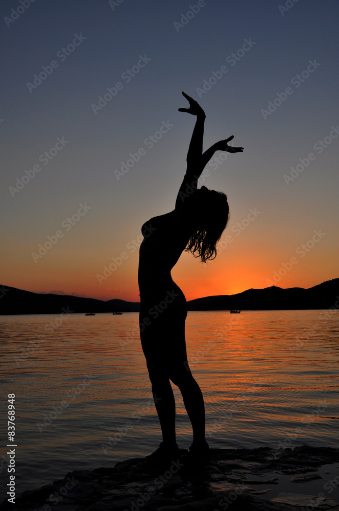 Sexy girl posing on the beach at sunset