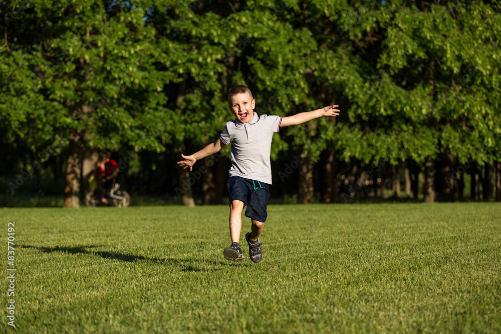 happy little boy laying on the grass