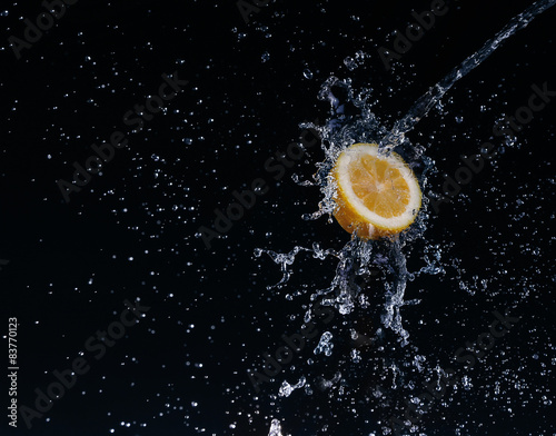 A high-speed shot of a lemon with splashing water