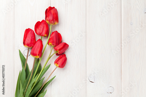 Fototapeta Naklejka Na Ścianę i Meble -  Red tulips bouquet over wood