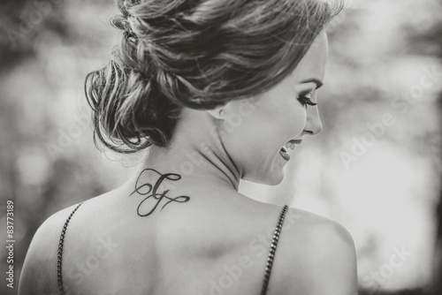 Portrait of young girl with tattoo on the neck photo