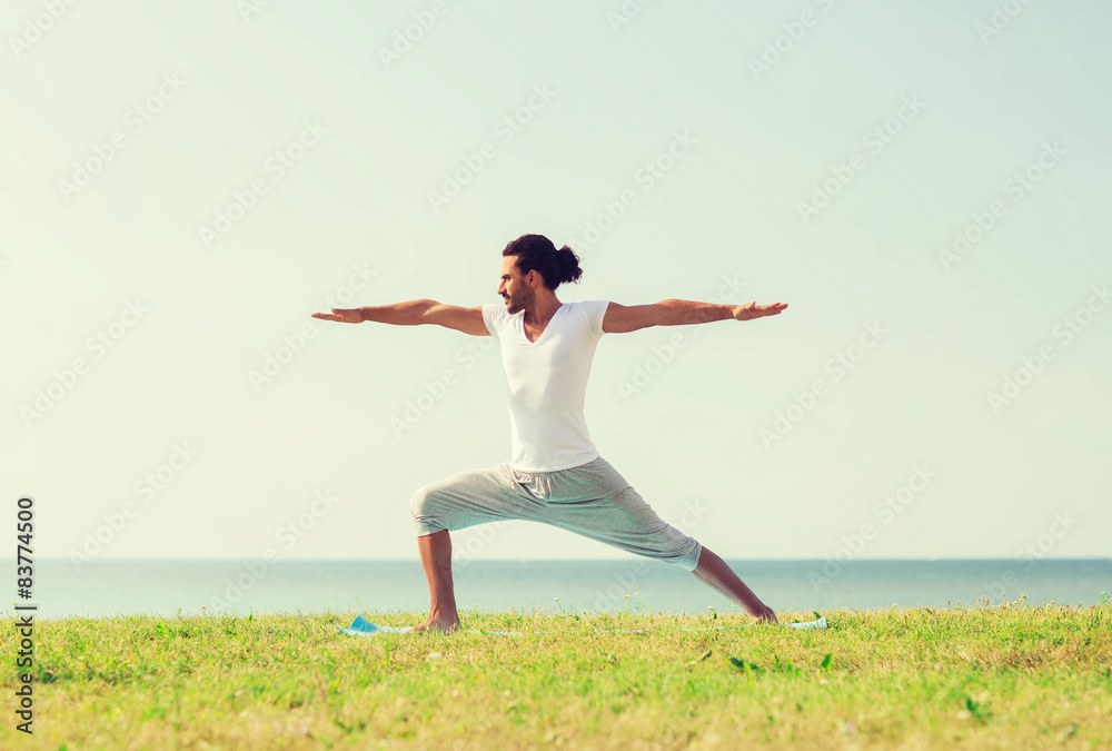 smiling man making yoga exercises outdoors smiling man making yoga exercises outdoors
