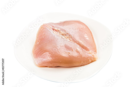 Fresh heart shaped skinless chicken breast meat on a plate