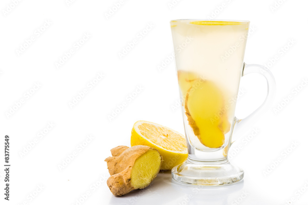 Hot ginger and lemon tea in transparent tall glass Hot ginger and lemon tea in transparent tall glass