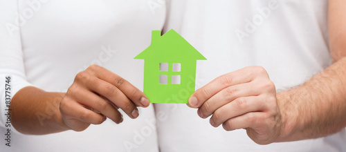 couple hands holding green house