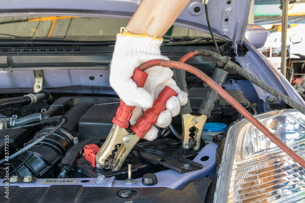 automotive technician charging vehicle battery automotive technician charging vehicle battery