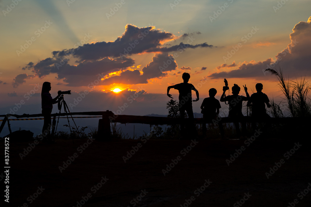 Photographers silhouetted before sun set Photographers silhouetted before sun set